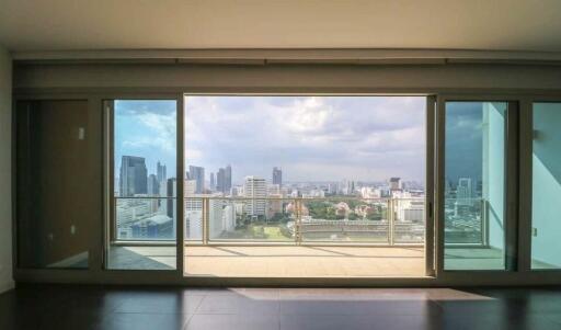 Spacious living room with large windows and city view