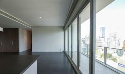 Modern living room with floor-to-ceiling windows and city view