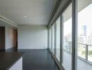 Modern living room with floor-to-ceiling windows and city view