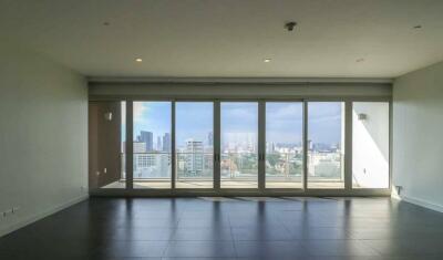 spacious living room with large windows offering city view