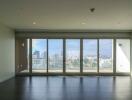 spacious living room with large windows offering city view