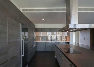 Modern kitchen with sleek dark cabinetry and built-in appliances