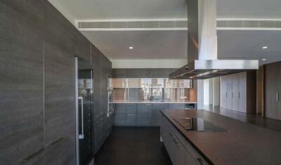 Modern kitchen with sleek dark cabinetry and built-in appliances