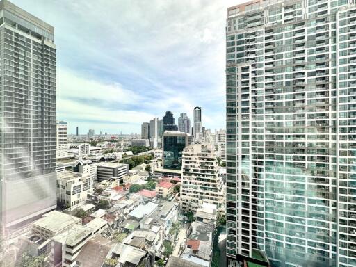 View of cityscape with tall buildings and residential area