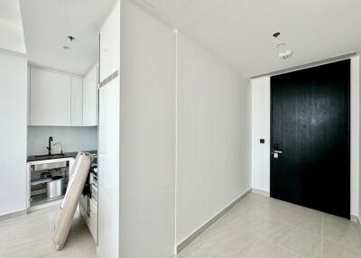 Modern white kitchen with black door