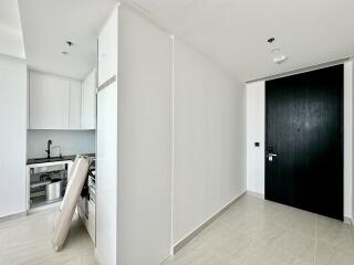 Modern white kitchen with black door