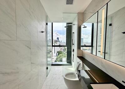 Modern bathroom with marble tiles and city view