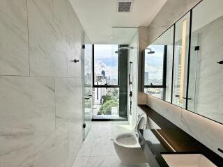 Modern bathroom with marble tiles and city view