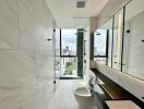 Modern bathroom with marble tiles and city view