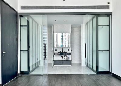 Modern bathroom with glass sliding doors and sleek black fixtures