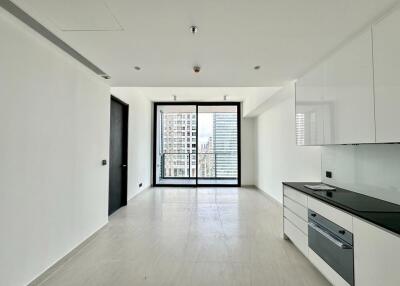 Modern living area with kitchenette and large windows