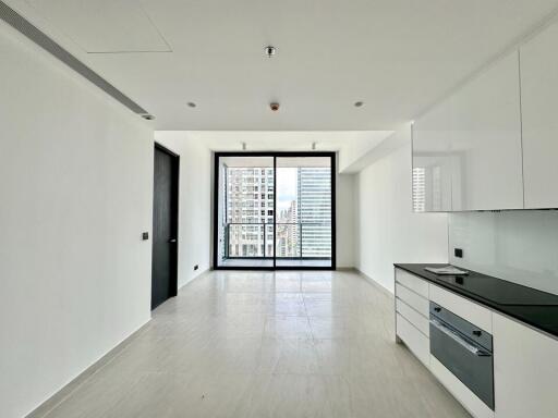 Modern living area with kitchenette and large windows