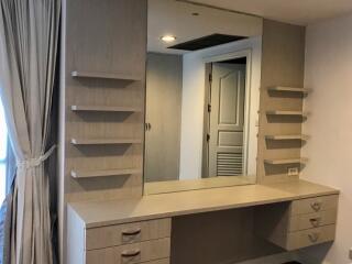 Bedroom vanity with mirror and shelves