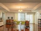 Spacious dining room with chandelier and wooden flooring