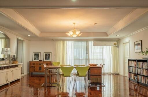 Spacious dining room with chandelier and wooden flooring