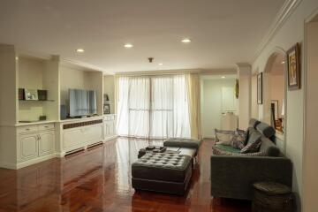 Spacious living room with hardwood floors and modern furnishings