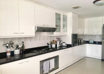 Modern kitchen with white cabinetry and appliances