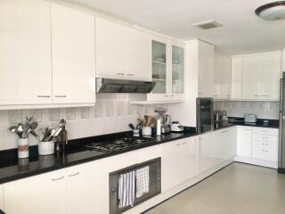 Modern kitchen with white cabinetry and appliances