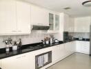 Modern kitchen with white cabinetry and appliances