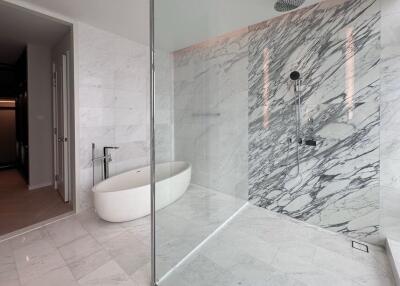 Modern bathroom with a marble shower and oval bathtub