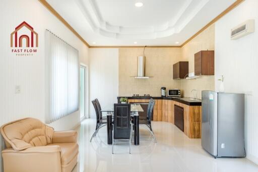 Modern kitchen and dining area with seating and appliances