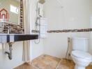 Modern bathroom with toilet, sink, shower, and tiled walls