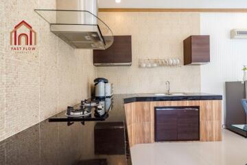 Modern kitchen with black countertops and wooden cabinets