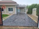 Front view of a single-story house with a wide driveway