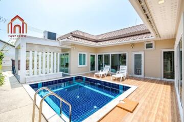 Outdoor private swimming pool area with sun loungers