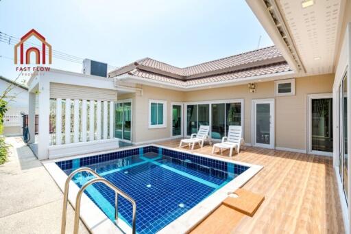 Outdoor private swimming pool area with sun loungers