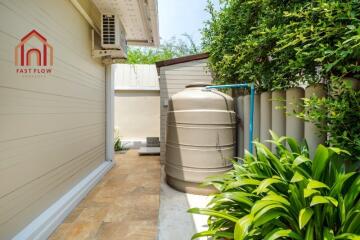 Outdoor area with water storage tank and green foliage