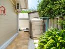 Outdoor area with water storage tank and green foliage