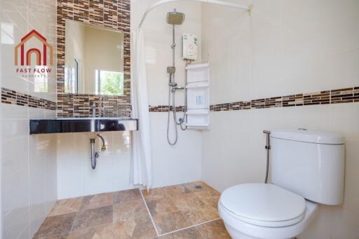 Modern bathroom with tiled flooring and shower area