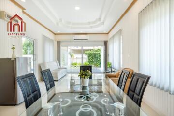 Modern living and dining area with large windows and contemporary furniture