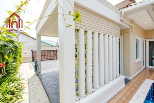 Outdoor area of a property with plants and a covered walkway