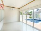 Modern living room with large sliding doors leading to a swimming pool