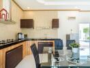 Modern kitchen with dining area and pool view