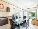 Modern kitchen and dining area with glass table and outdoor view