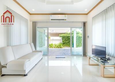 Modern living room with large windows and a garden view