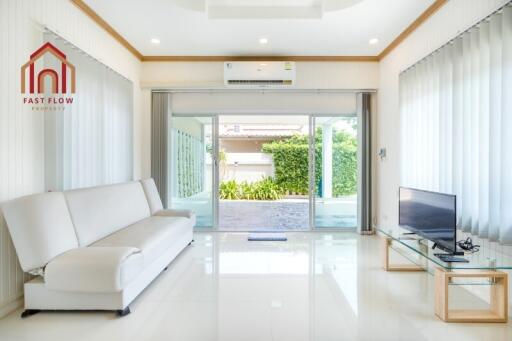 Modern living room with large windows and a garden view