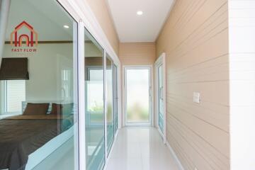 Bright hallway with sliding glass doors and a bedroom entrance