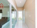 Bright hallway with sliding glass doors and a bedroom entrance