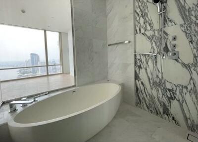 Modern bathroom with marble finishes and a large oval bathtub