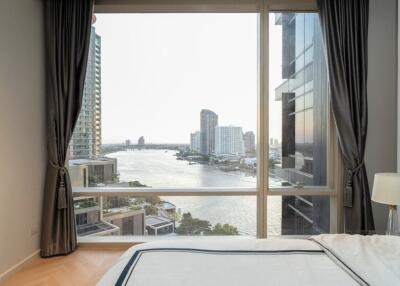 Bedroom with large window and river view