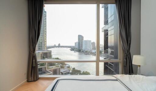 Bedroom with large window and river view