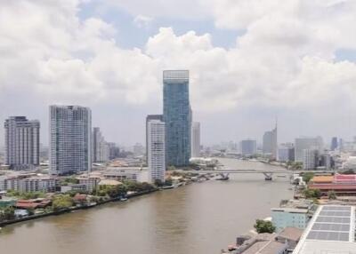 Aerial view of cityscape with river and high-rise buildings