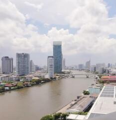 Aerial view of cityscape with river and high-rise buildings