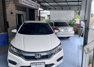 Covered garage with two parked cars