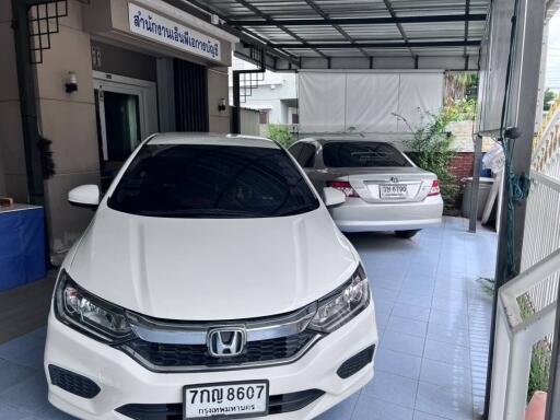 Covered garage with two parked cars