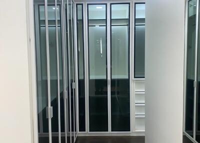 Modern walk-in closet with glass doors